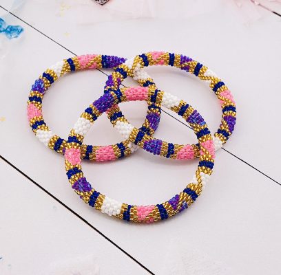 3 pcs nepal bracelets featuring bold purple, pink, gold and white beads